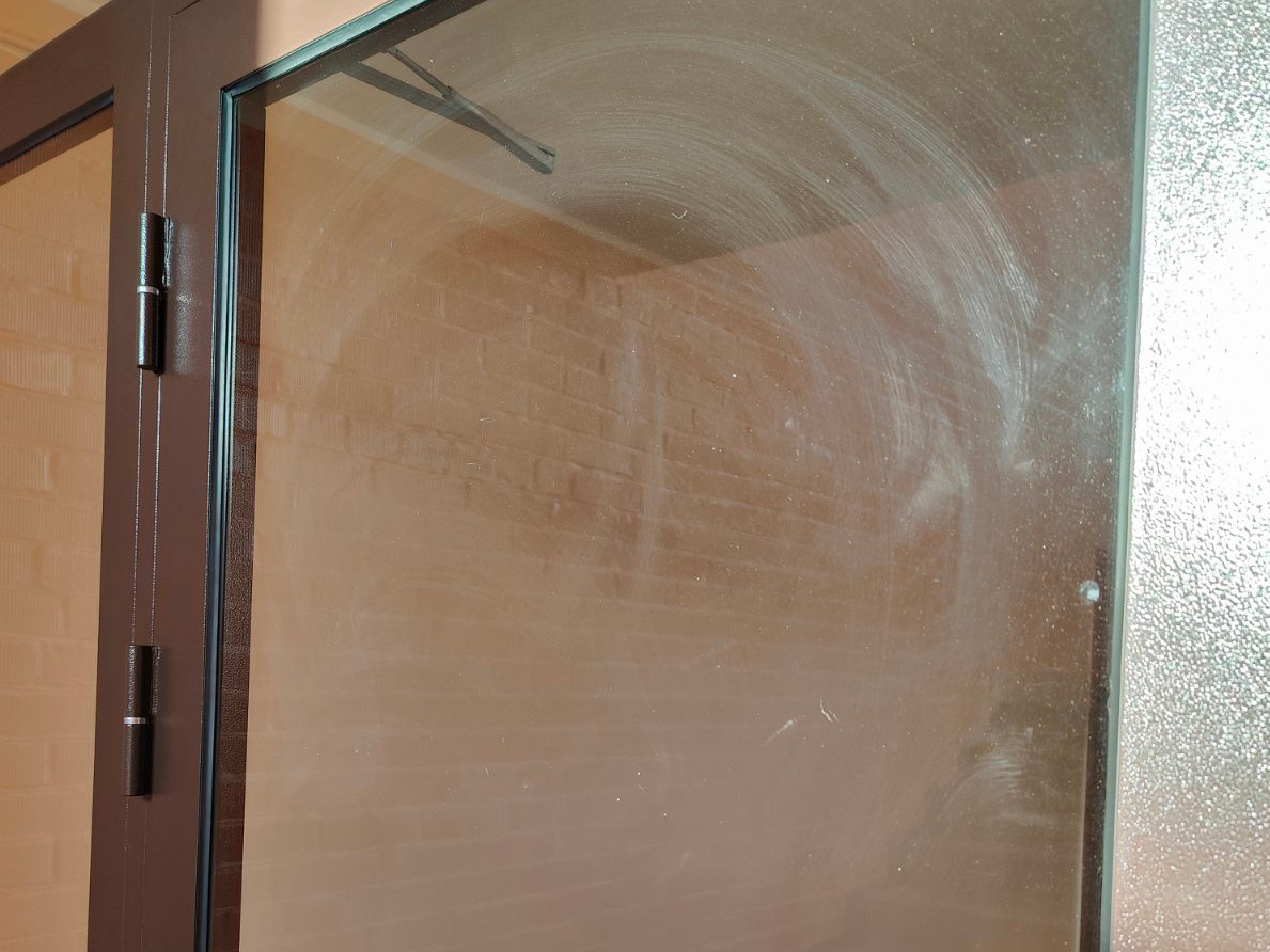 A door glass with visible wiping marks